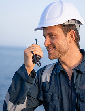 Enermar employee talking on radio while coordinating delivery of fuel to ship